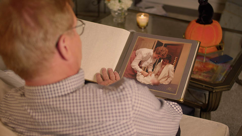 Man looking at baby photo album