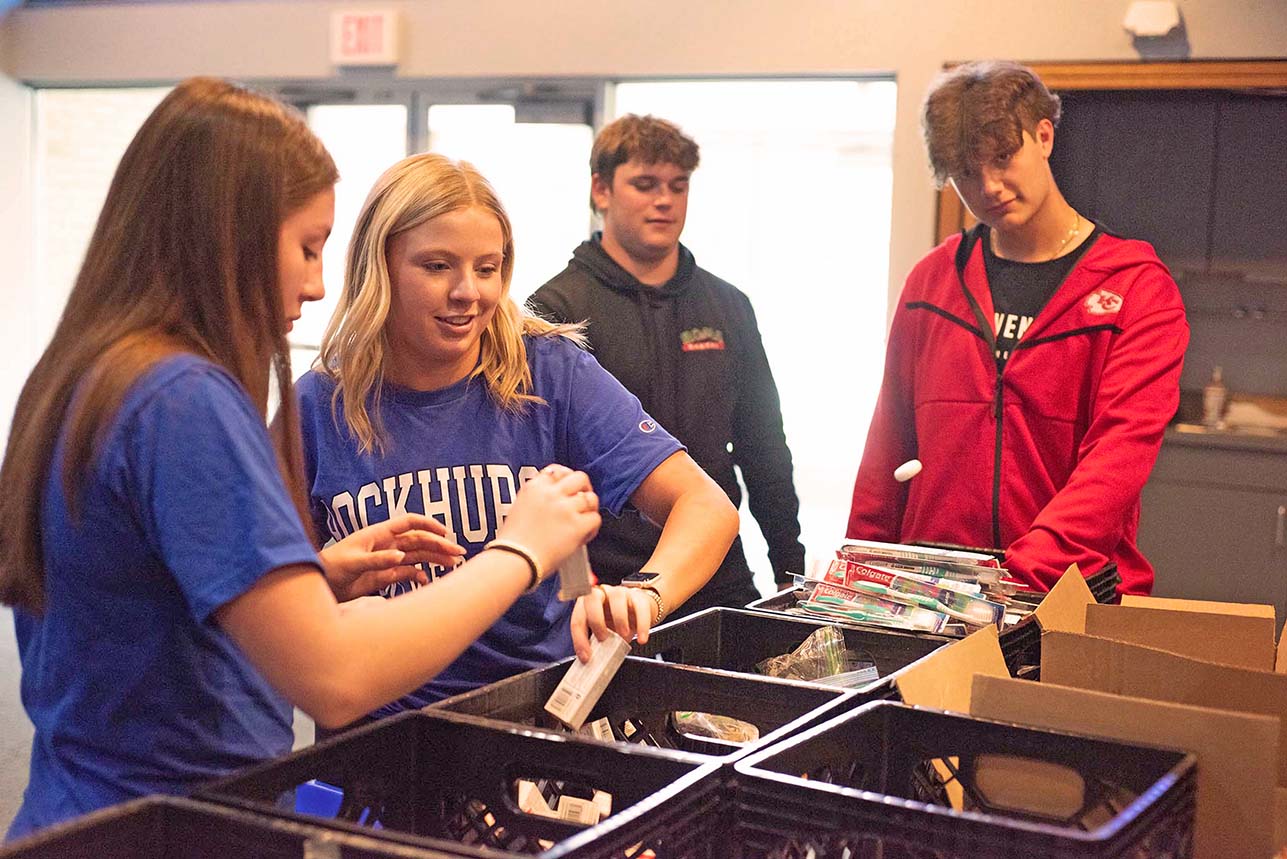 Teens sort donated toiletries for a cause.
