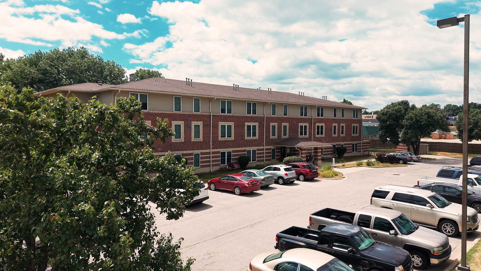 Senior living building exterior with parking