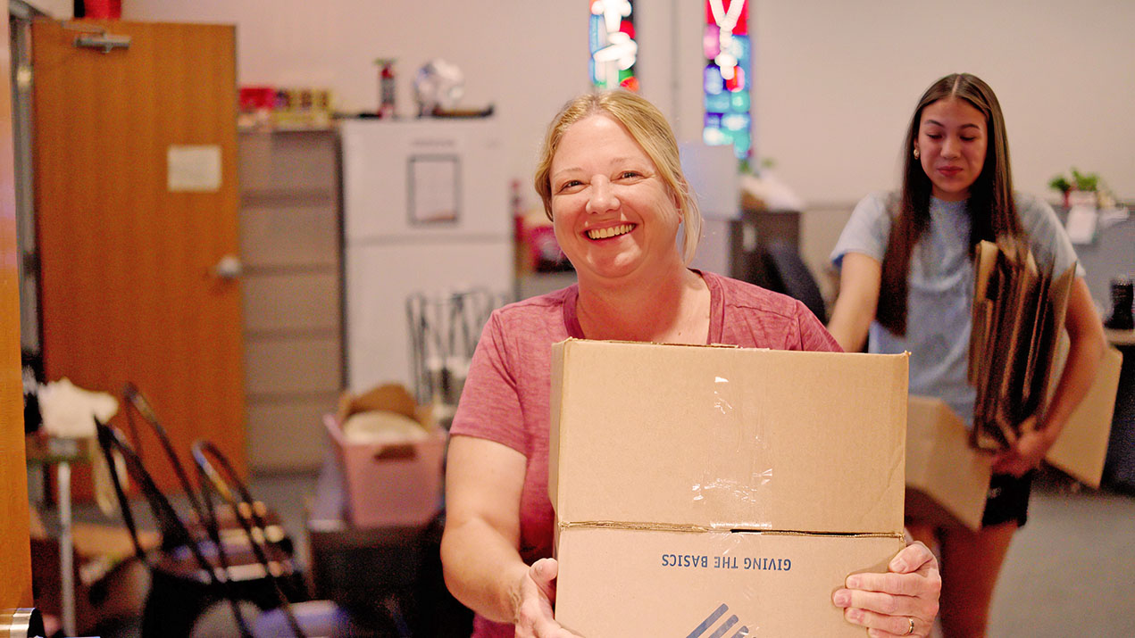 Woman and girl carrying boxes
