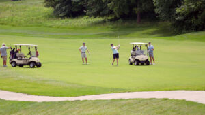 Golfers on course with carts