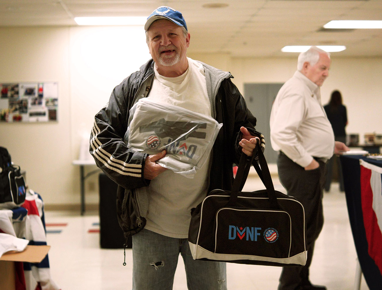 Man holding bags with DNFN logo