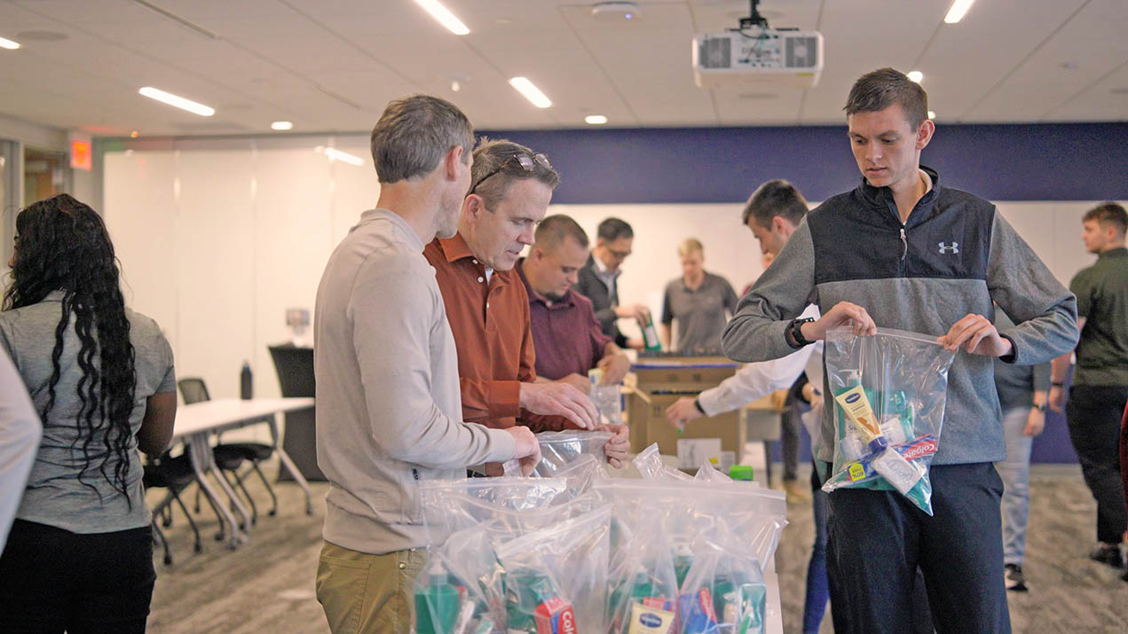 Volunteers pack hygiene kits for community