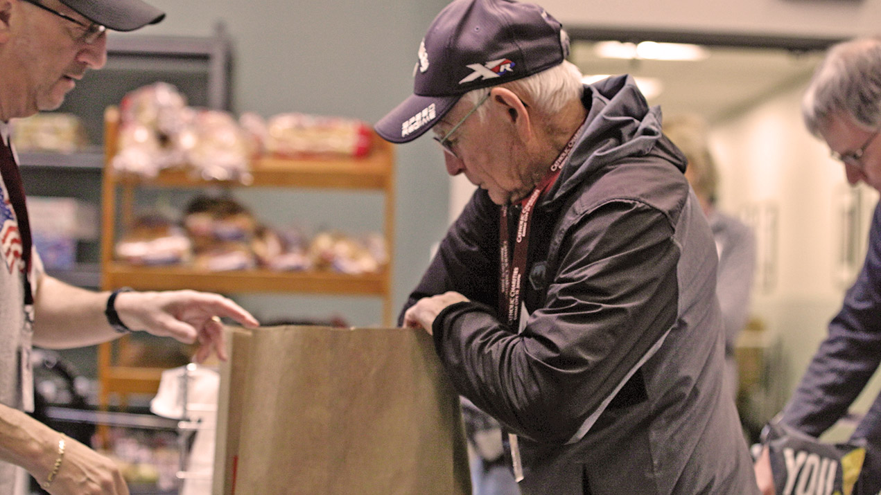 Man packing food donation bag