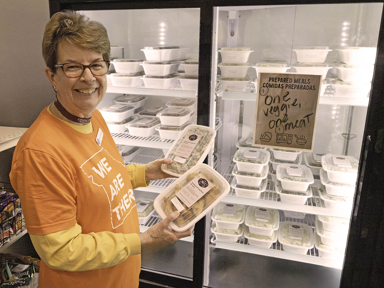 Woman holding prepared meals from fridge