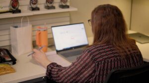 Woman working on laptop at desk