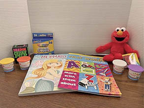 Elmo, crayons, and activity books