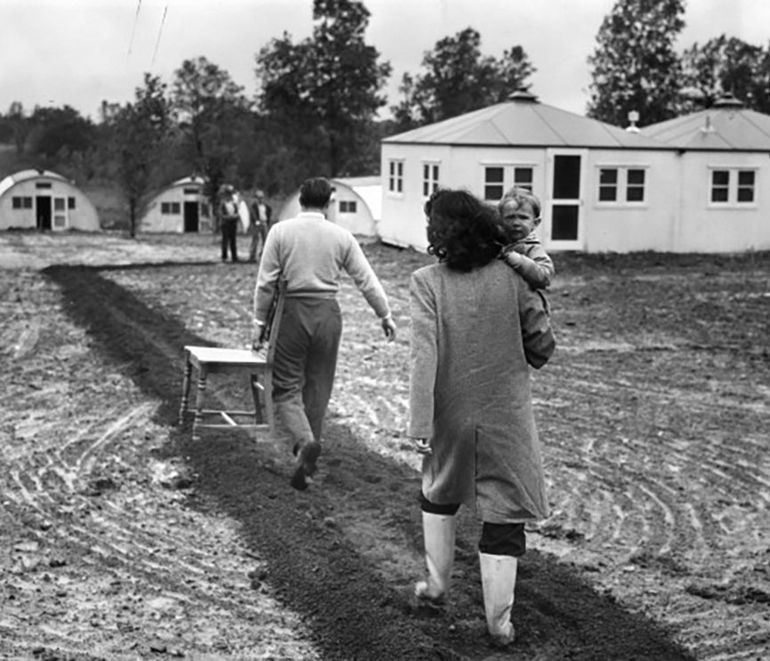 Family walks towards barracks