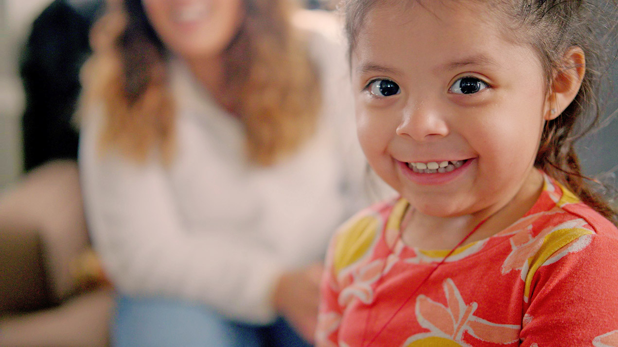 Happy little girl smiling at camera