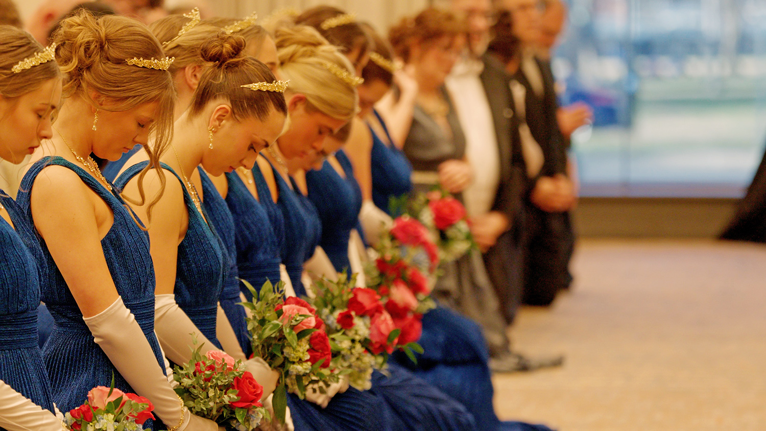 Young women in blue dresses with flowers