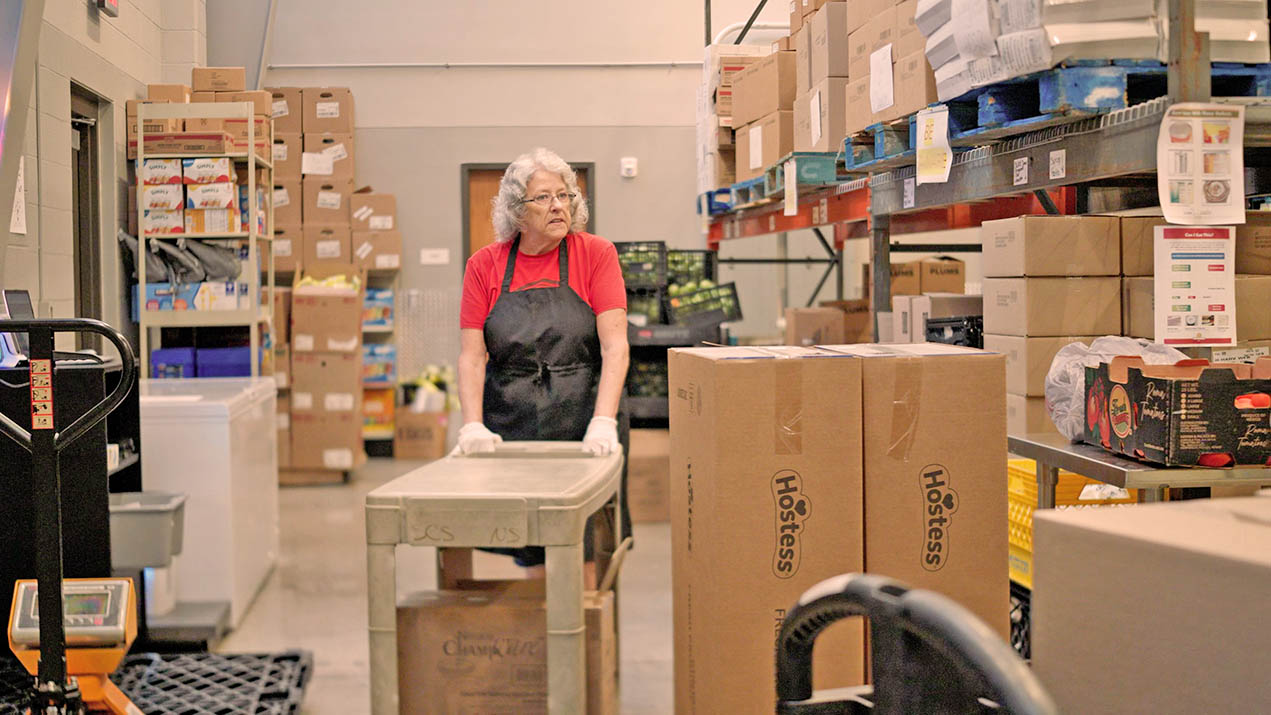 Woman pushing cart in warehouse