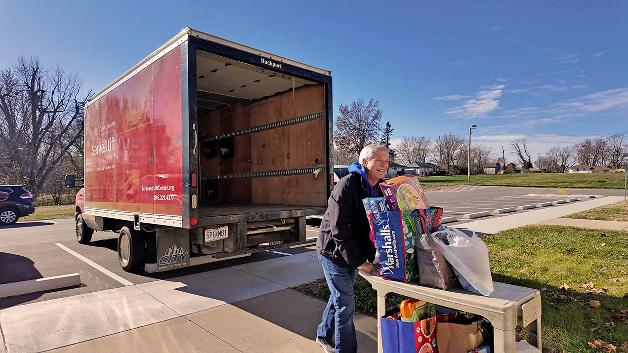 Woman loading donations into a truck