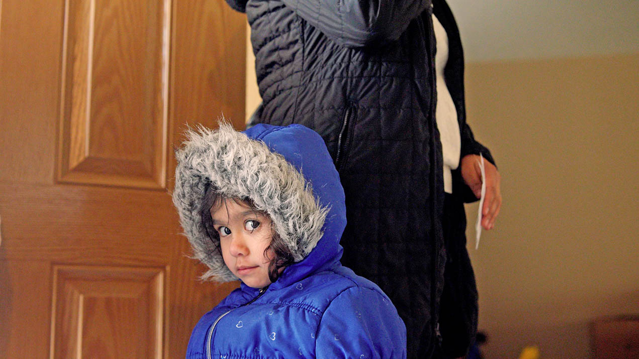 Child in blue hooded coat