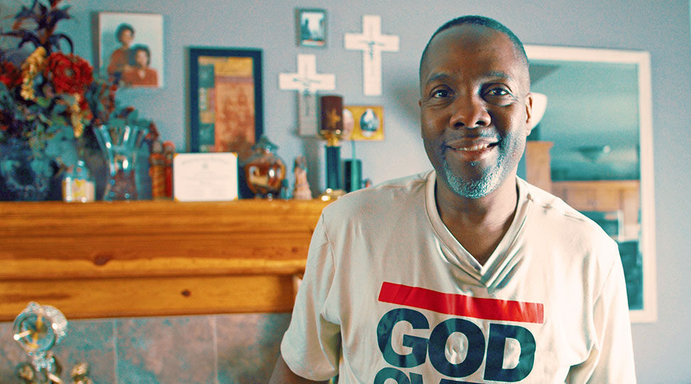 Man in "God Over Everything" shirt