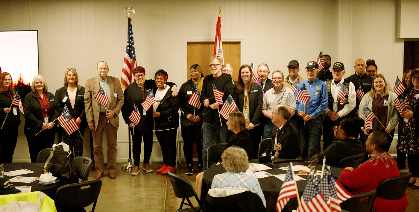 Veterans and supporters hold American flags