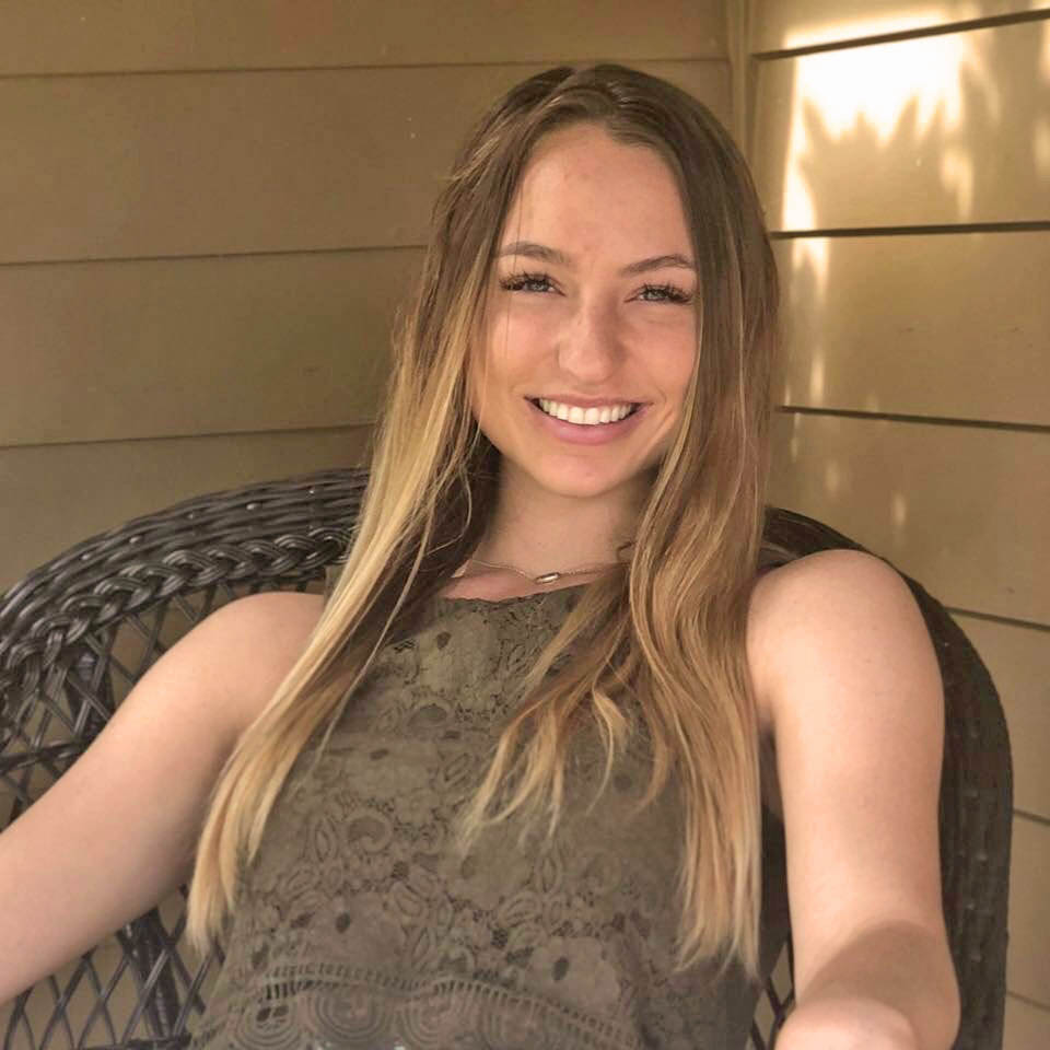 Young woman smiling on porch