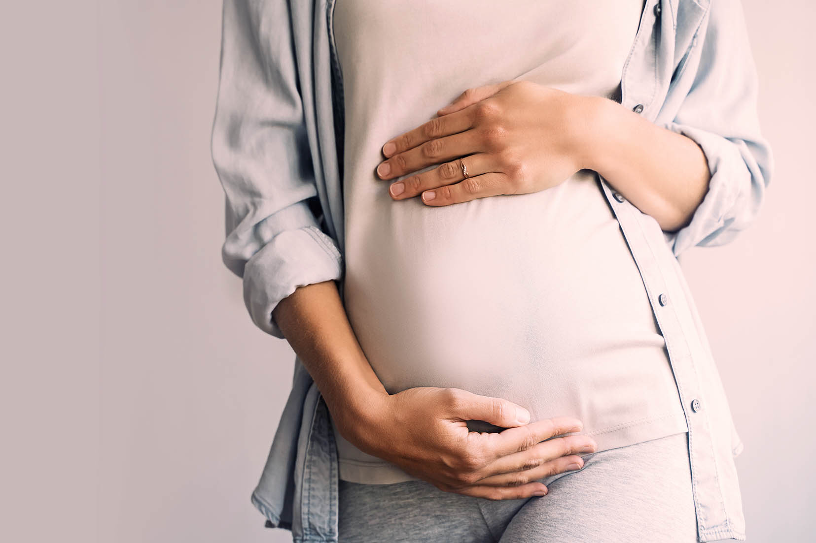 Pregnant woman holding her belly