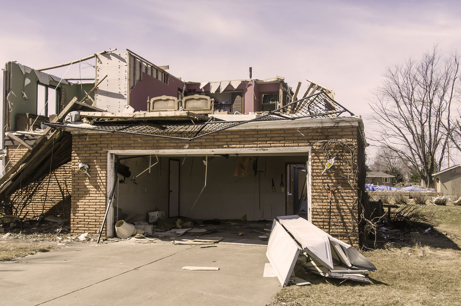 Tornado damage to brick house and garage