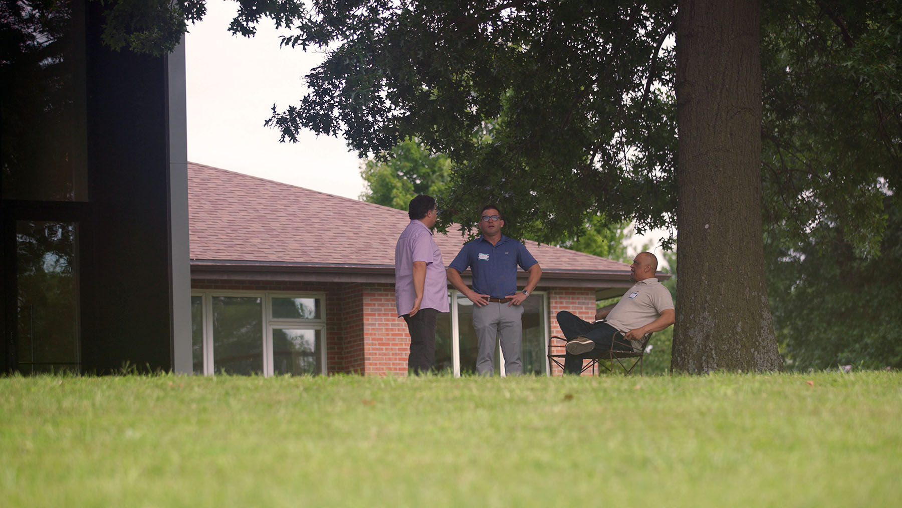 Men talking outside modern house