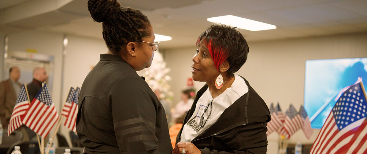 Two women talking at an event
